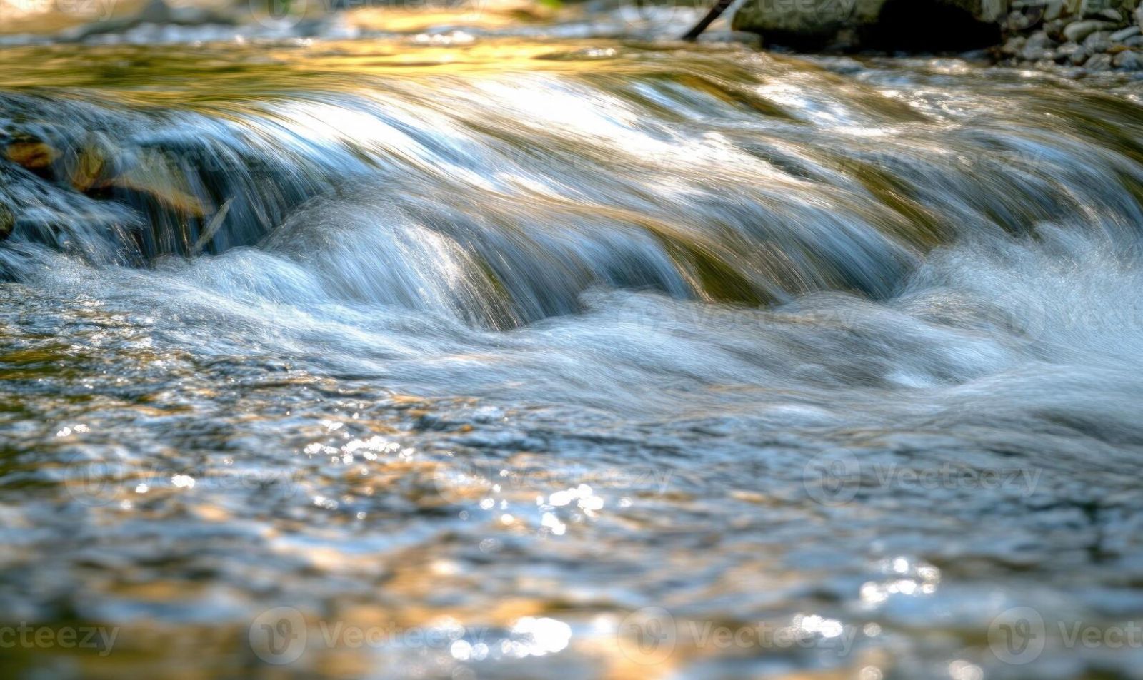 close-up-of-a-flowing-river-sunlight-reflecting-on-the-water-photo.jpg